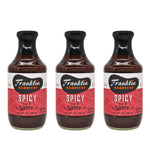 Three bottles of Franklin Barbecue Spicy BBQ Sauce arranged side by side on a white background.