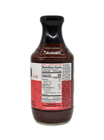 A bottle of Franklin Barbecue Spicy BBQ Sauce with a black cap and a label showing the nutrition facts, set against a plain white background.