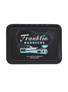 Franklin Barbecue An Austin Original Since 2009 text. Drawing of the restaurant building in white and light blue on a black tray.