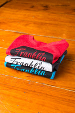 Stack of folded toddler kids Franklin Barbecue t-shirts.