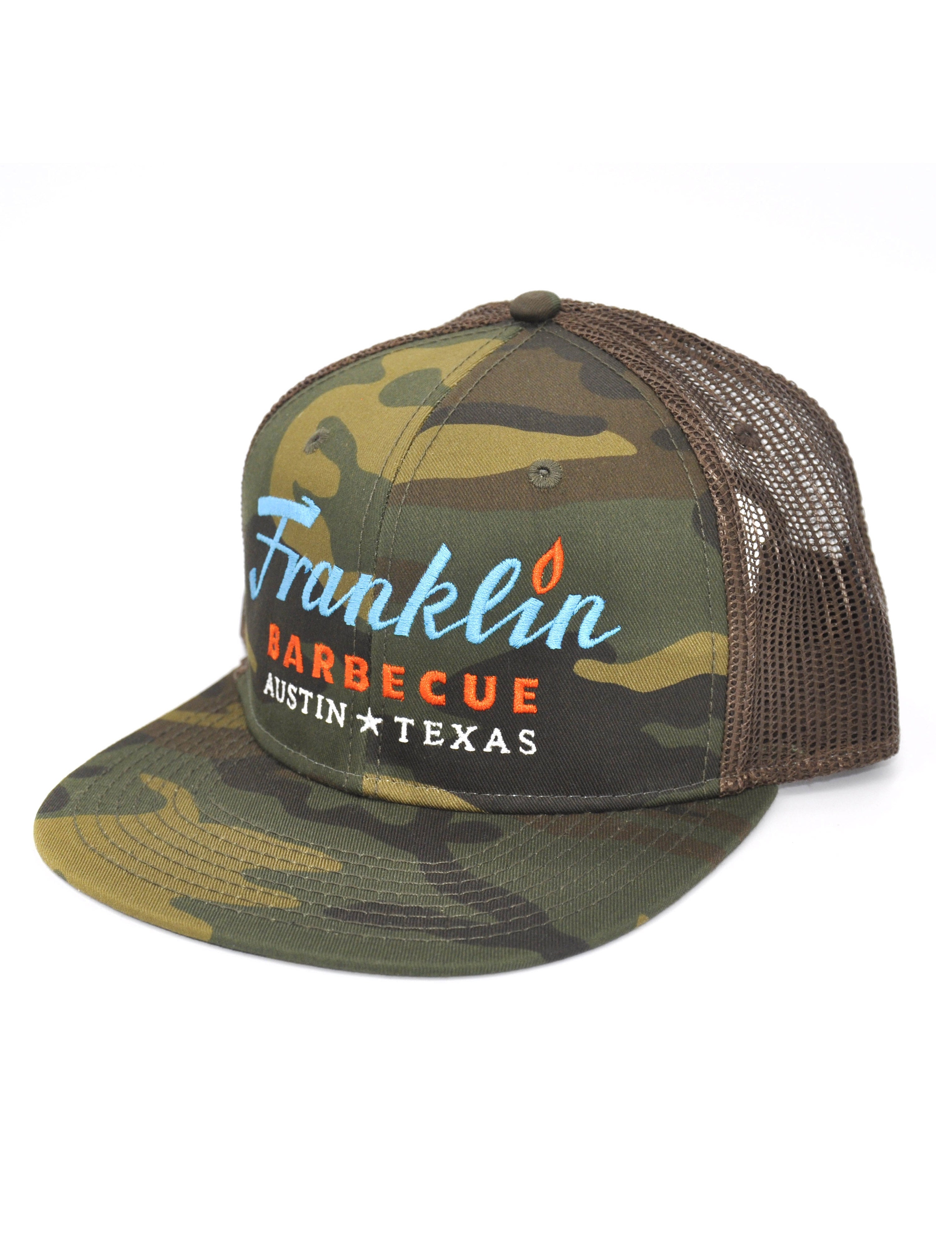 Alternate angle that shows the mesh backing of Camouflage cap with Franklin Barbecue text logo in blue and orange. Below that is Austin Texas in white. 