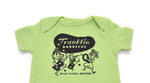 Key Lime Green onesie with Franklin Barbecue bean Logo in black and logo of dancing family holding the letters B-B-Q while wearing pig-nose masks also in black. Below the dancing family is the address of Franklin Barbecue also in black.
