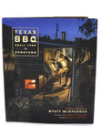 Cover of Wyatt McSpadden's book Texas BBQ Small Town to Downtown. Image shows Aaron Franklin looking into smoker.