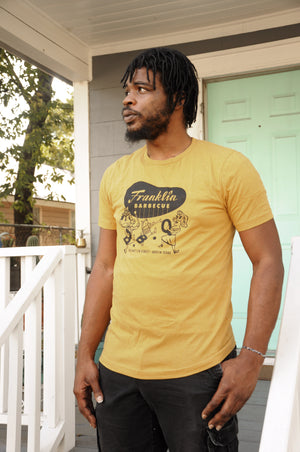 Model wearing heather yellow Franklin Barbecue t-shirt.