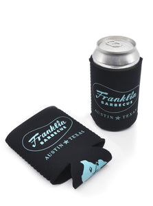 Two Black coldie holdie with Franklin Barbecue bean logo outlined in blue with Austin Texas below it also in blue; one is laid flat the other is shown with can inside