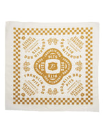 Full display of tan Franklin BBQ Pits bandana to show detail of patterned design which includes a checkered border and text logos saying "Handmade in Austin Texas, Backyard Smoker"