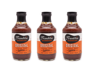 Trio of Franklin Barbecue Original Sauce bottles.