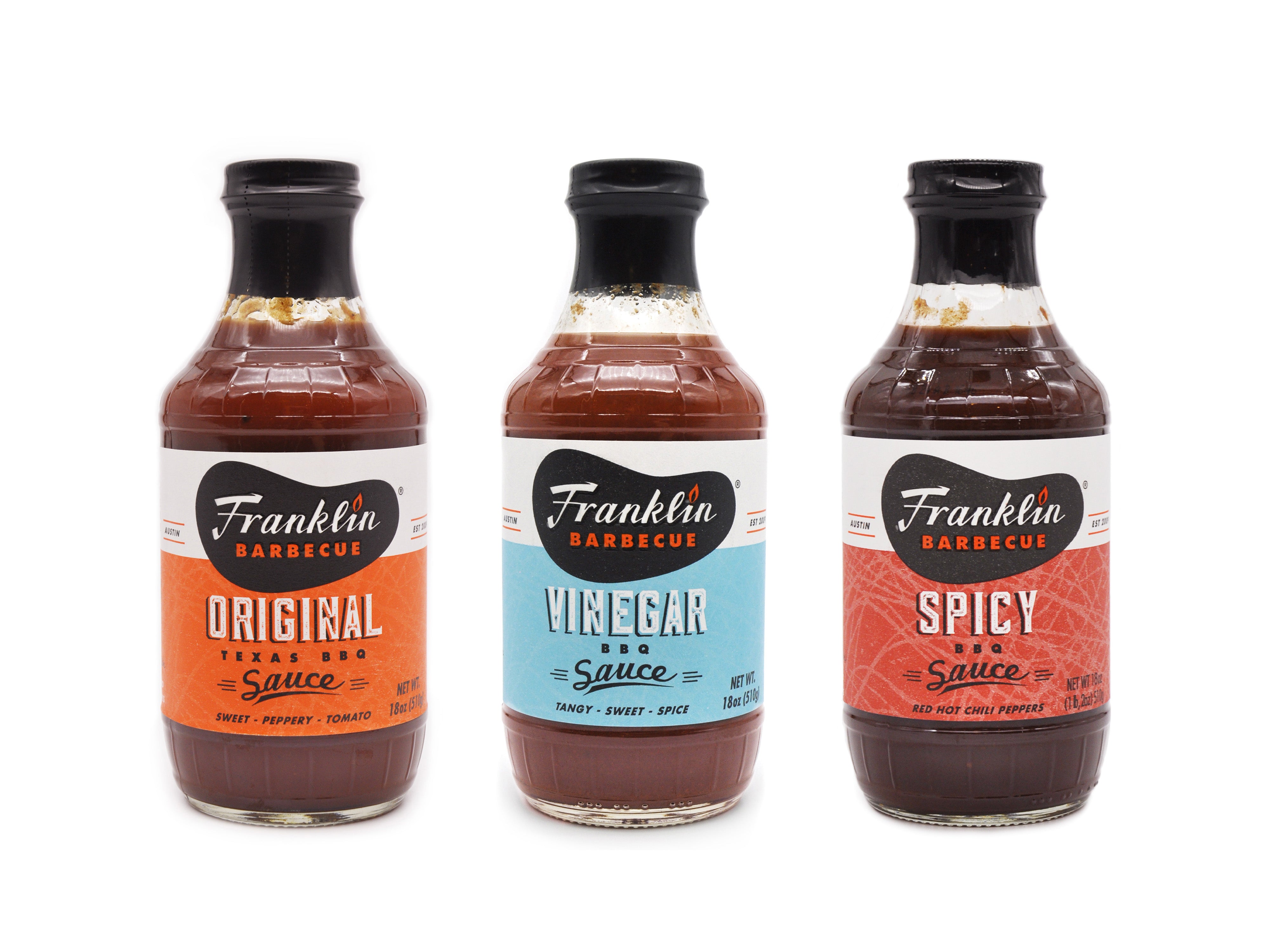 Trio of Franklin Barbecue sauces. One bottle each of original sauce, vinegar sauce and spicy sauce.
