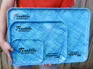 Photo of all three Franklin Barbecue serving trays, offered in small, large and extra large sizes., held together to show dimensional contrast. All are Swirl Blue color.